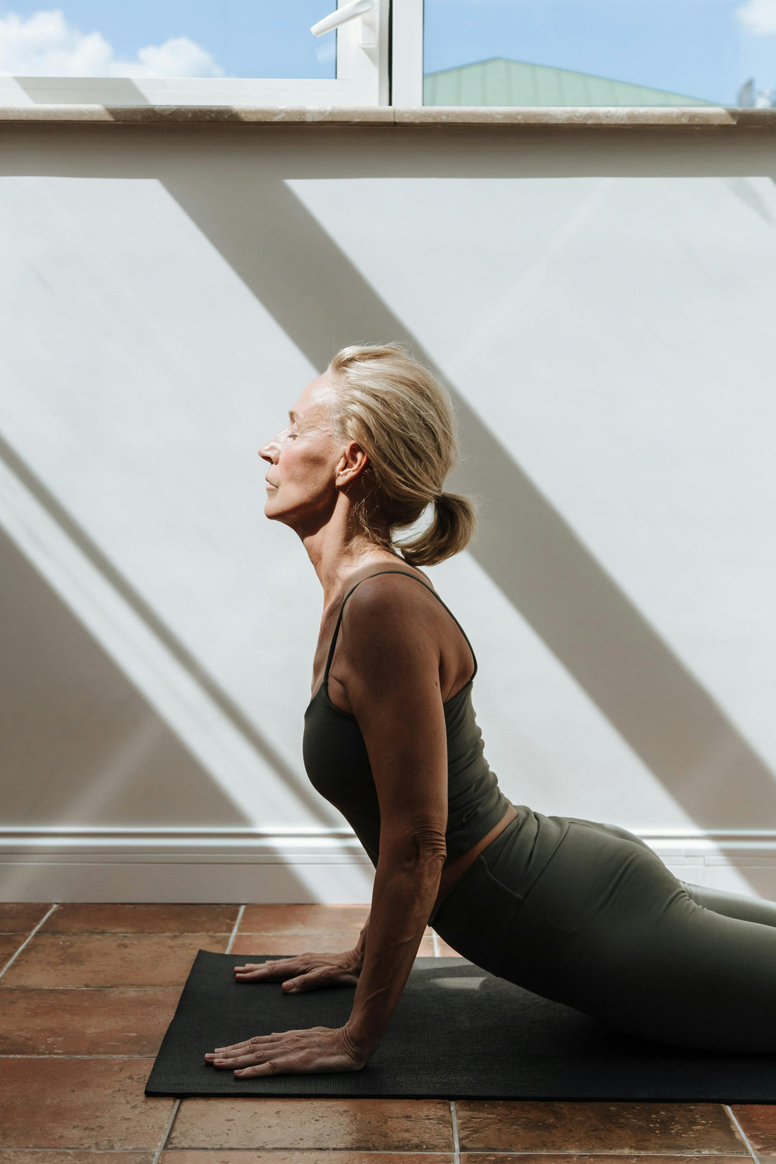 Woman practicing yoga indoors showcasing the Top 5 Benefits of Energy Strips.