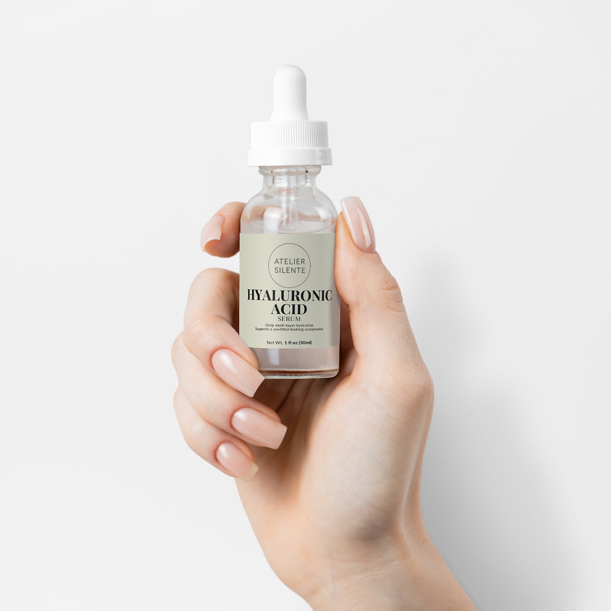 Hand holding a bottle of Hyaluronic Acid Serum for deep hydration and glowing skin.