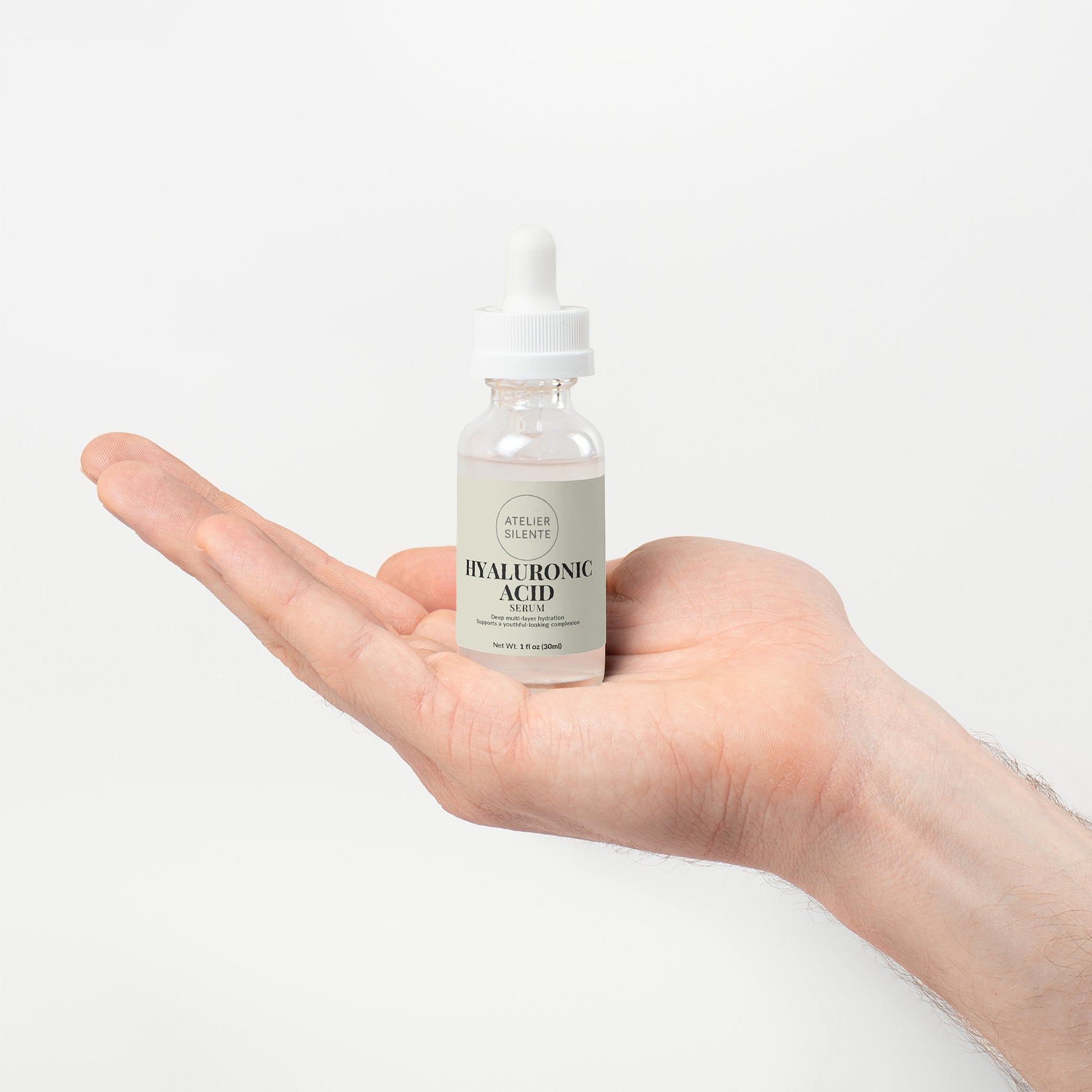 Hyaluronic Acid Serum bottle held in hand showcasing deep hydration for skin.