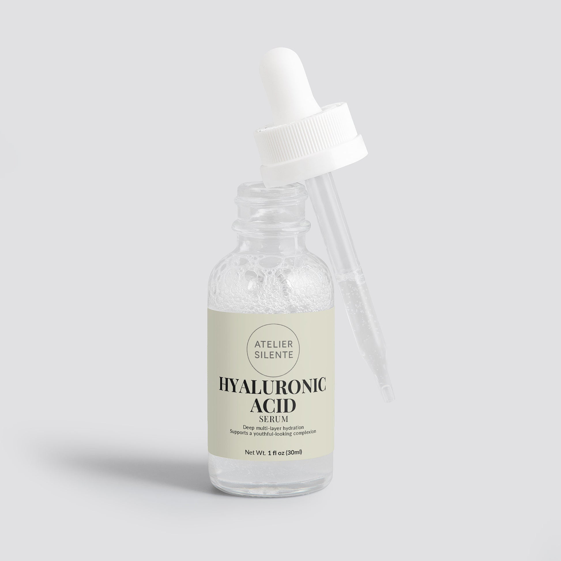 Hyaluronic Acid Serum bottle with dropper for deep, dewy hydration and glowing skin, promoting skin bounce and moisture.