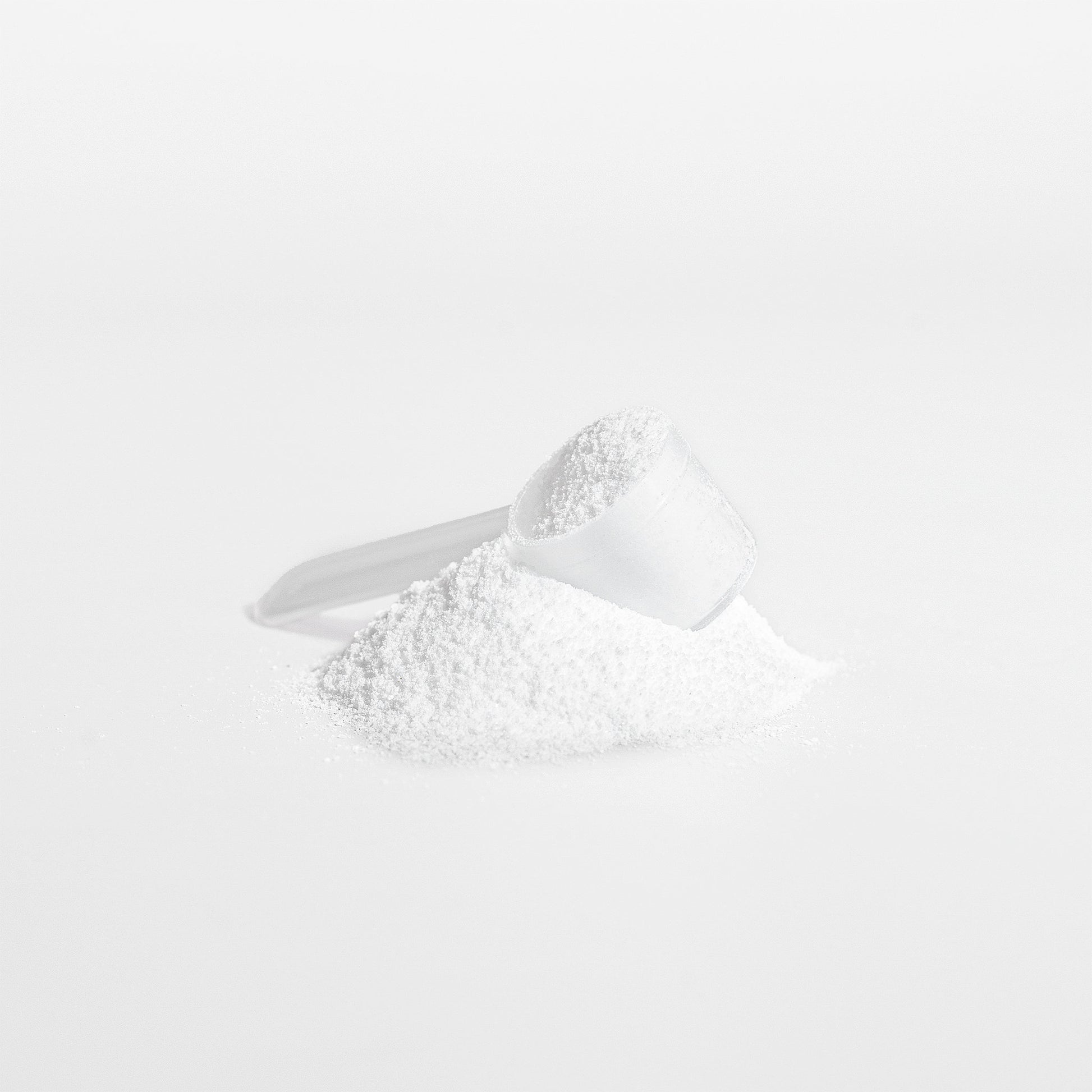 Creatine Monohydrate powder with a measuring scoop for enhanced fitness performance.